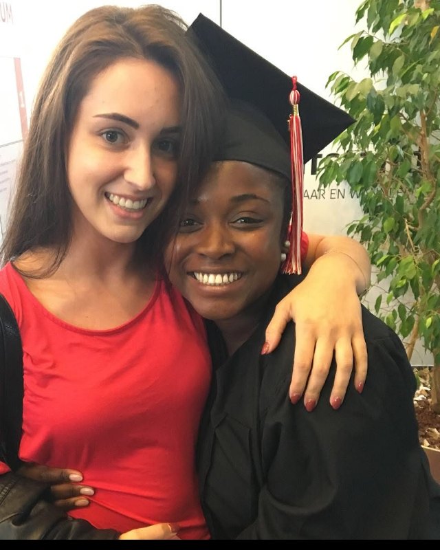 Magnolia with her diploma and a friend